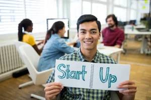 Young entrepreneur at startup office showing benefits of sales training in Bangalore